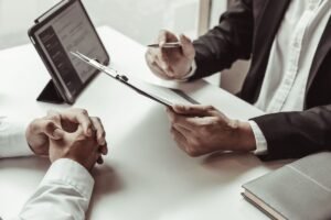 Candidate preparing for a marketing interview with notes and laptop